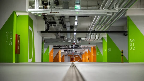 Stock image Inside View of Large Underground Car Park in the Shopping Mall Divided Into Colored Sectors and Equipped with Professional HVAC System.