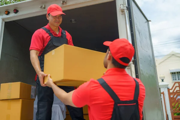 Diligent workers unload belongings from a truck, diligently preparing to move them into a new house. Their efficient teamwork ensures a smooth transition and marks the beginning of a fresh chapter in the homeowners\' lives.
