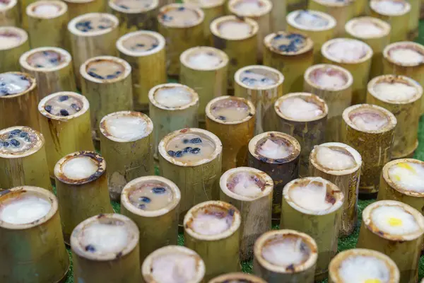 おいしいカオラム ココナッツミルクと黒豆のタイの粘着米 地元の市場で表示される竹の管で蒸した ストックフォト