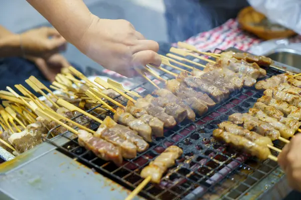 Step into the realm of culinary delight as skewers of succulent meat dance on the grill. The tantalizing aroma wafts through the air, promising a savory experience. Watch as each skewer caramelizes to perfection, offering a symphony of flavors that c