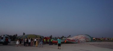Luxor, Egypt, July, 12, 2022: Preparing a balloon to make a sightseeing flight over the Valley of the Kings in Luxor, Egypt
