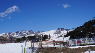Soldeu, Andorra, Nisan, 04, 2023: Güneşli bir günde, Paskalya tatillerinde Andorra 'daki bir tatil beldesinde kayak manzarası