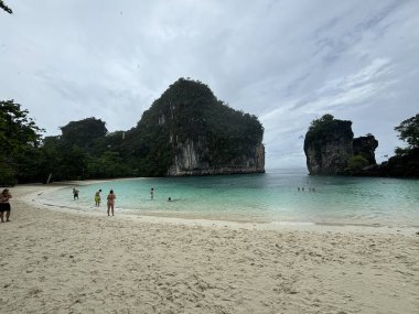 Beyaz kumlu ve mavi gökyüzü olan tropik bir sahil