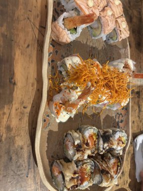 Acevichado Roll (Tempered Shrimp, Avocado, Topped with Sea Bass, Acevichada Sauce, Çıtır Tatlı Patates)