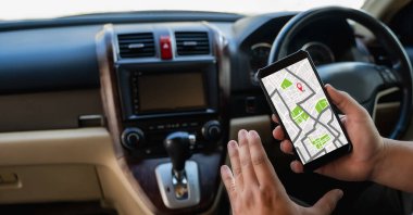 A man makes use of GPS and the internet. online map in the car controls the navigator for GPS tracking.