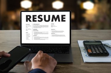 Businessmen Reading Resumes for a new job use laptops and CVs in the office. Applicant searching for new work Human resource interview, work resume, document resource