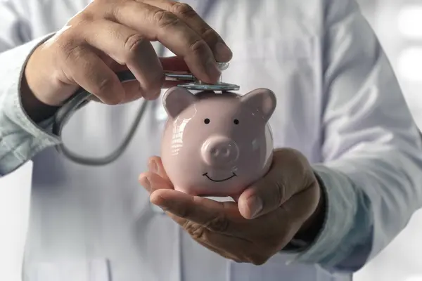 Doctors medical saving money on health care insurance to insurance plan finance Piggy bank money