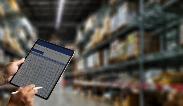 Warehouse management engineer holding tablet management dashboard Electronic inventory management concept