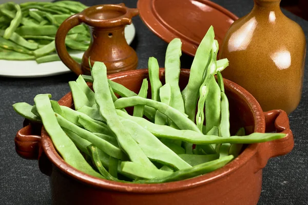 Green beans. Clay pot with green beans.