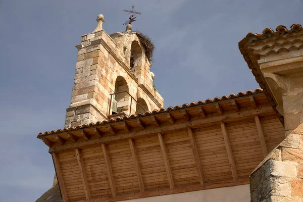 stock image San Pedro neighborhood, (Cervera de Pisuerga), Spain, June 14, 2023. Church of San Andrs. Bell tower with a nest. It is located in the Barrio de San Pedro