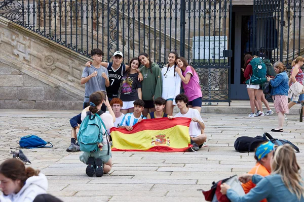 stock image Santiago de Compostela, June 30, 2023. Pilgrims in Compostela. People from different places celebrate their arrival before the Cathedral, after having completed the Camino de Santiago.