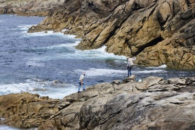 Punta Roncudo (İspanya), 9 Mayıs 2024. Balıkçılar. Balıkçılar çubuklarını suya atıyorlar. Costa de la Muerte 'de bir uçuruma. Galiçya kıyı şeridinin tehlikeli bir bölgesi..