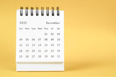 December 2022 Monthly desk calendar for 2022 year on yellow background.