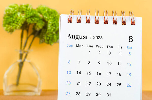 August 2023 Desk calender on yellow background.