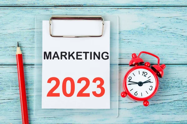 2023 Marketing, Goal and Target Setting List for 2023 year with alarm clock. Change and determination concept.
