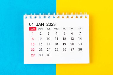 2023 Ocak ayının masa takvimi mavi ve sarı arka plan üzerine.
