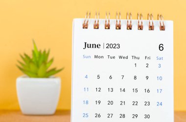 June 2023 Monthly desk calendar for 2023 year on yellow background.