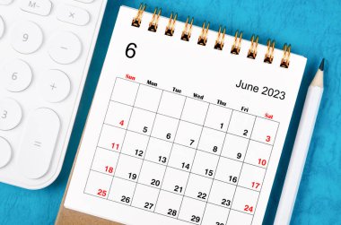 June 2023 Monthly desk calendar for 2023 year with calculator and wooden pencil. clipart