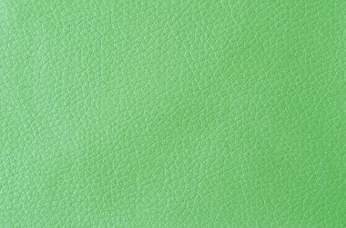 Arka planda gölgesi olan yeşil deri dokusu.