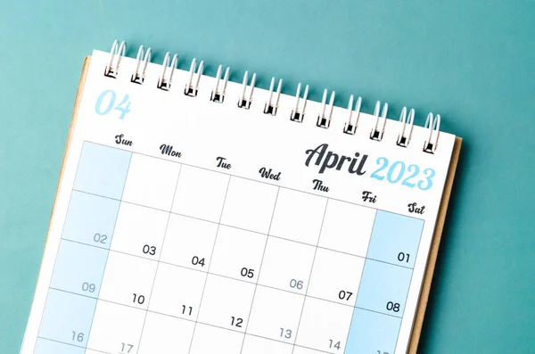 April 2023 calendar desk for the organizer to plan and reminder isolated on blue background.