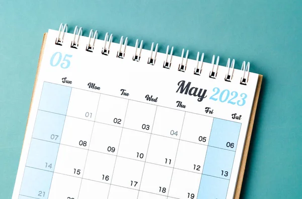 May 2023 calendar desk for the organizer to plan and reminder isolated on blue background.