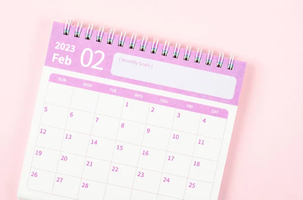 February 2023 calendar desk for the organizer to plan and reminder isolated on pink background.