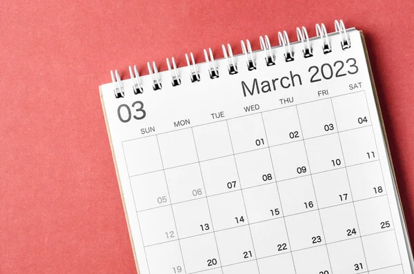 March 2023 calendar desk for the organizer to plan and reminder isolated on red background.