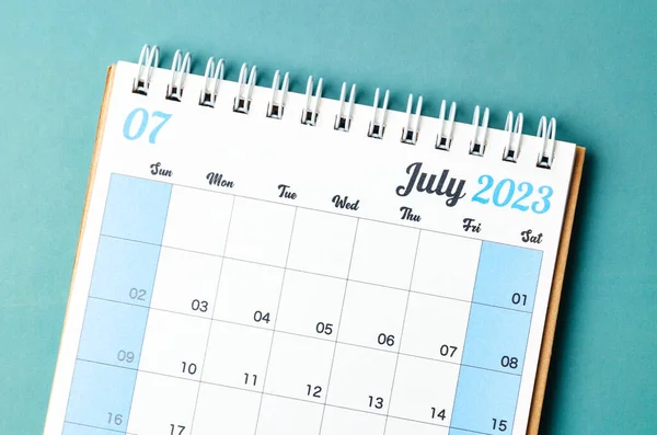 July 2023 calendar desk for the organizer to plan and reminder isolated on blue background.