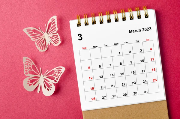 March 2023 calendar desk for the organizer to plan and reminder with butterfly paer on red background.