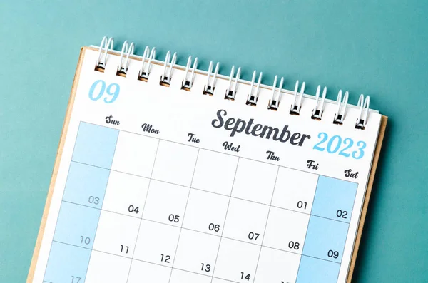 September 2023 calendar desk for the organizer to plan and reminder isolated on blue background.