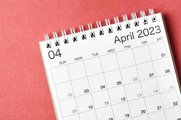 April 2023 calendar desk for the organizer to plan and reminder isolated on red background.