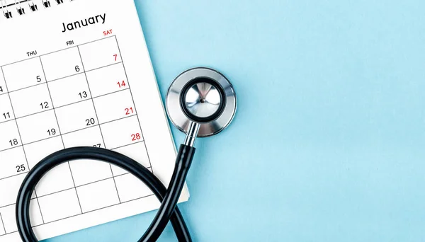 Stethoscope medical and calendar with empty space on the blue background, schedule to check up healthy concepts.
