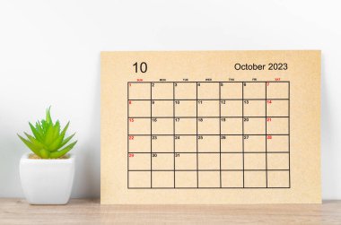 October 2023 Monthly calendar for 2023 year on wooden table.