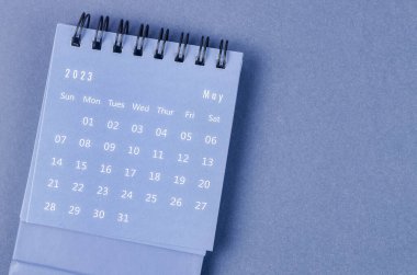 May 2023 Monthly desk calendar for 2023 year on blue background.