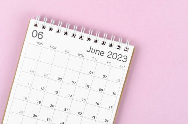 June 2023 calendar desk for the organizer to plan and reminder isolated on pink background.