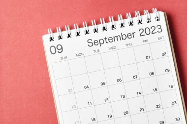 September 2023 calendar desk for the organizer to plan and reminder isolated on red background.