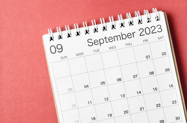 September 2023 calendar desk for the organizer to plan and reminder isolated on red background.