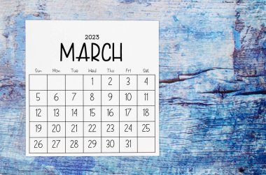 March 2023 Monthly calendar for 2023 year on old blue wooden background.