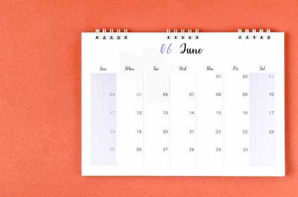 June 2023 calendar desk for the organizer to plan and reminder on red background.