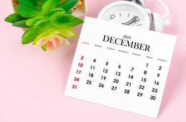 December 2023 Monthly calendar for 2023 year with vintage alarm clock on pink colour background.