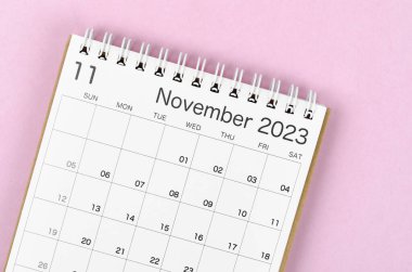 November 2023 calendar desk for the organizer to plan and reminder isolated on pink background.