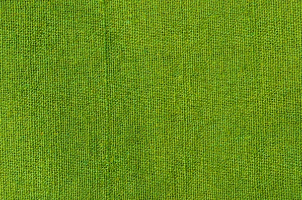 Green cotton fabric texture as background natural textile.