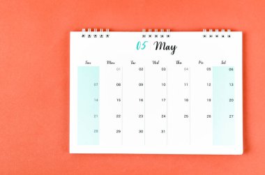 Kırmızı zemin üzerinde planlama ve hatırlatma için Mayıs 2023 takvim masası.