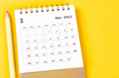 March 2023 Monthly desk calendar for 2023 with pencil on yellow background.