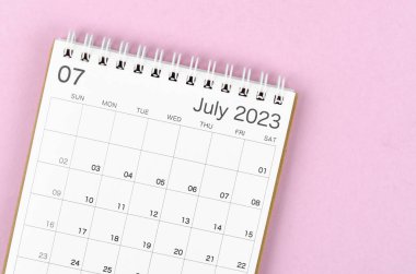 July 2023 calendar desk for the organizer to plan and reminder isolated on pink background.