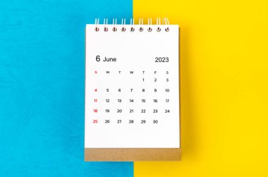 June 2023 Monthly desk calendar for 2023 year on blue and yellow background.
