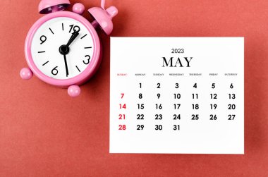 May 2023 Monthly calendar year for 2023 year with alarm clock on red background.