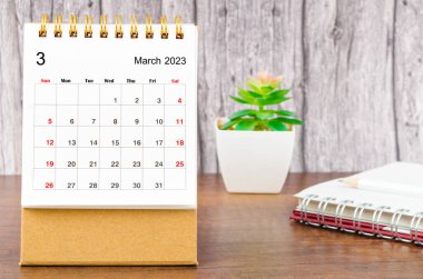 March 2023 Monthly desk calendar for 2023 year with pencil and diary.