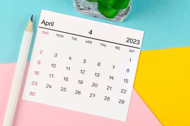 April 2023 Monthly calendar for 2023 year with pen on beautiful background.