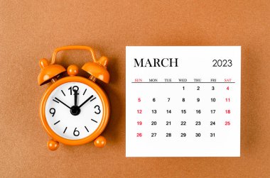 March 2023 Monthly calendar for the organizer to plan 2023 year with alarm clock on yellow background.
